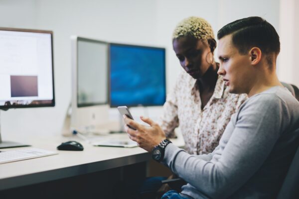 Programmers cooperating at information technology company